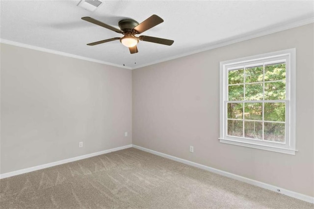 unfurnished room with carpet flooring, crown molding, ceiling fan, and baseboards