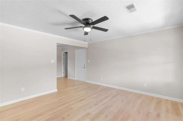 unfurnished room with light wood-type flooring, ceiling fan, baseboards, and ornamental molding