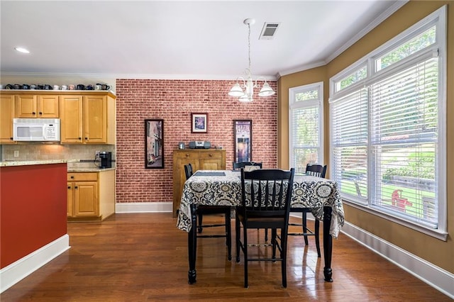 1997 Shaker Falls Ln, Lawrenceville, GA 30045 - dining area featuring baseboards, crown molding, a chandelier, healthy amount of natural light, and dark wood-type flooring