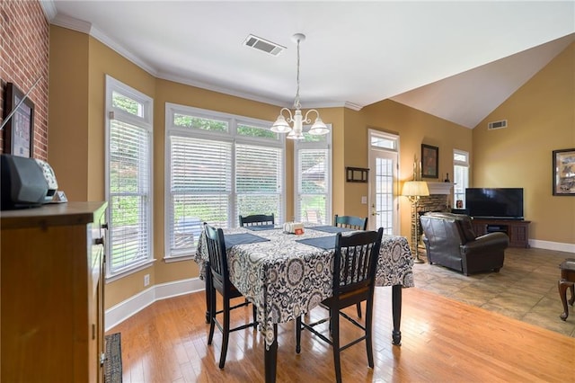 1997 Shaker Falls Ln, Lawrenceville, GA 30045 - dining area featuring a chandelier, baseboards, plenty of natural light, ornamental molding, and vaulted ceiling