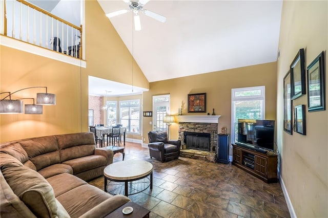 1997 Shaker Falls Ln, Lawrenceville, GA 30045 - living room with high vaulted ceiling, baseboards, plenty of natural light, ceiling fan, and a stone fireplace