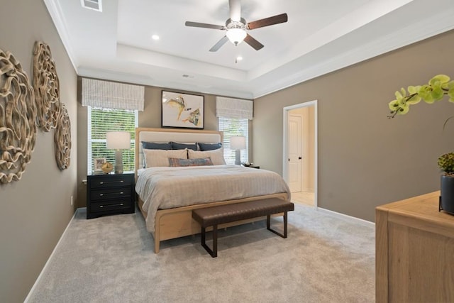 bedroom with baseboards, a ceiling fan, light colored carpet, a tray ceiling, and recessed lighting