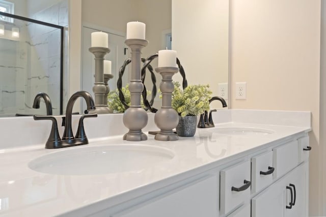 interior details with a sink, a marble finish shower, and double vanity