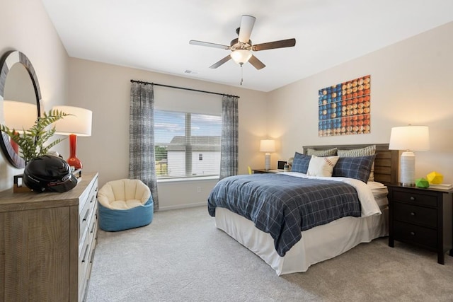 bedroom featuring baseboards, a ceiling fan, and light colored carpet