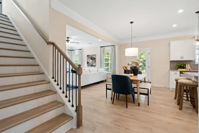 dining room with recessed lighting, baseboards, ornamental molding, stairway, and light wood-type flooring