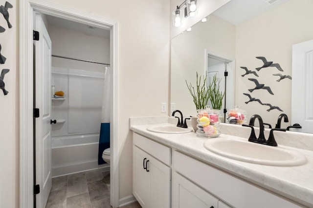 bathroom featuring double vanity, shower / bathtub combination with curtain, toilet, and a sink