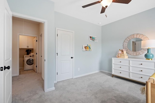 carpeted bedroom featuring washer / dryer, baseboards, and a ceiling fan