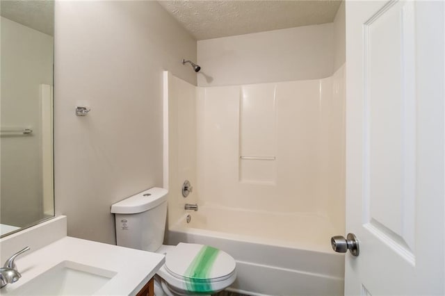 bathroom with shower / bath combination, a textured ceiling, vanity, and toilet