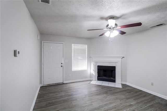 unfurnished living room featuring visible vents, baseboards, wood finished floors, and a ceiling fan