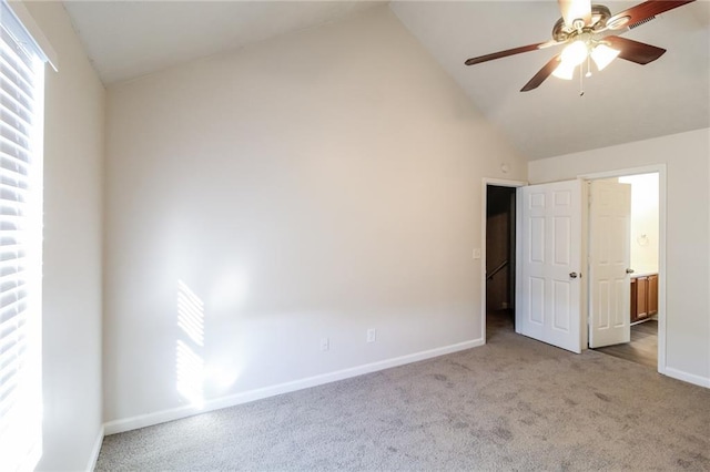 unfurnished bedroom with lofted ceiling, multiple windows, and carpet floors