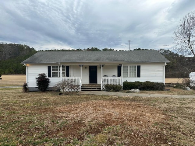 single story home featuring covered porch and a front lawn