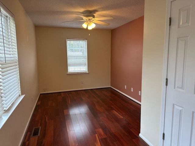 unfurnished room featuring ceiling fan, dark hardwood / wood-style floors, and a textured ceiling