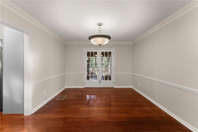 unfurnished dining area featuring ornamental molding, dark hardwood / wood-style flooring, and french doors