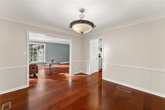 unfurnished room featuring dark wood-type flooring and ornamental molding