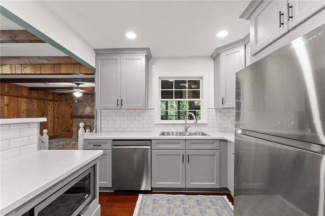 kitchen with decorative backsplash, sink, appliances with stainless steel finishes, and gray cabinets