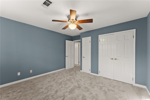 unfurnished bedroom with ceiling fan and light colored carpet