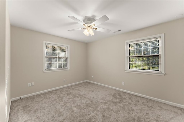 spare room featuring ceiling fan and light colored carpet