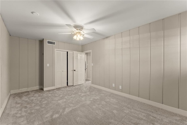 unfurnished bedroom featuring ceiling fan and light carpet