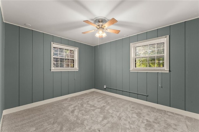 spare room with ceiling fan and light carpet