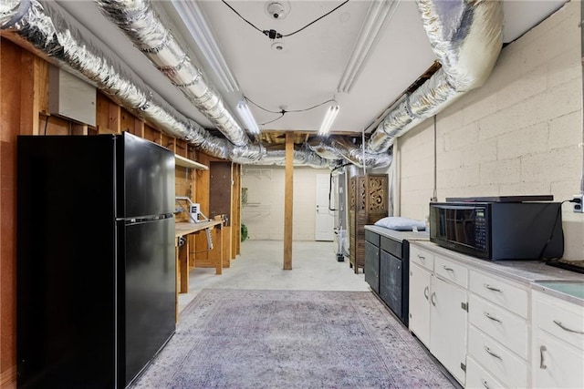 kitchen featuring white cabinets and black appliances