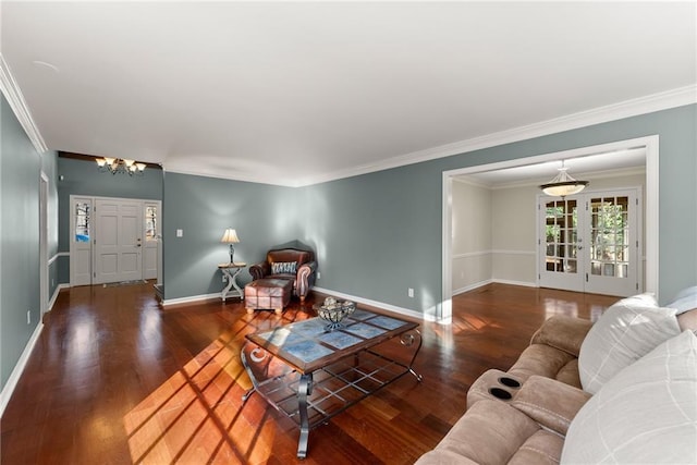 living room with dark hardwood / wood-style floors, crown molding, and an inviting chandelier