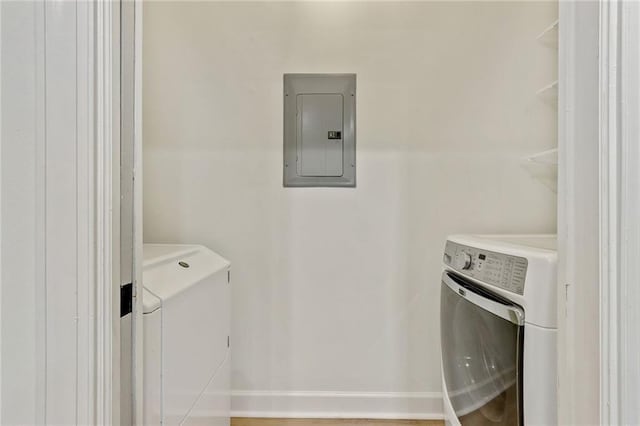 laundry room with electric panel and washer and dryer