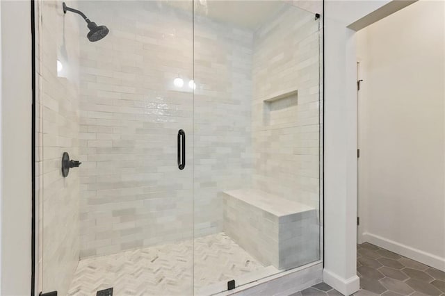 bathroom featuring tile patterned flooring and a shower with shower door