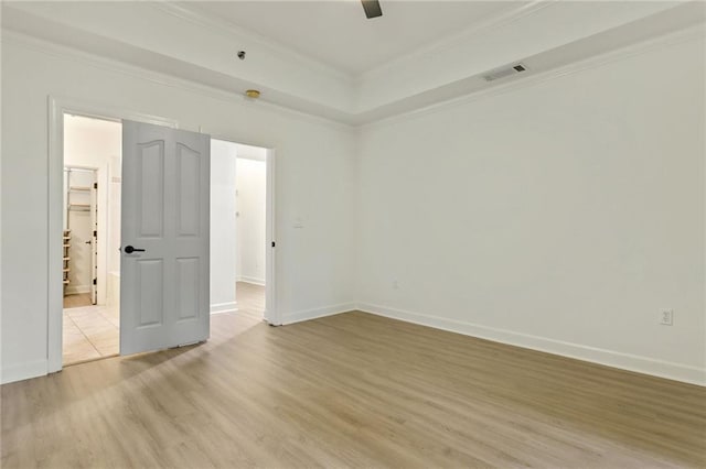 unfurnished room with light wood-type flooring and crown molding