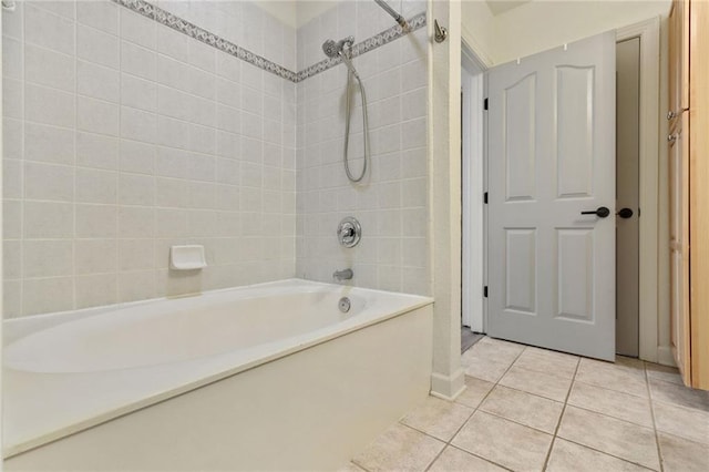 bathroom with tile patterned floors and tiled shower / bath