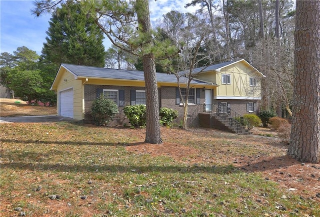 tri-level home featuring a garage and a front yard