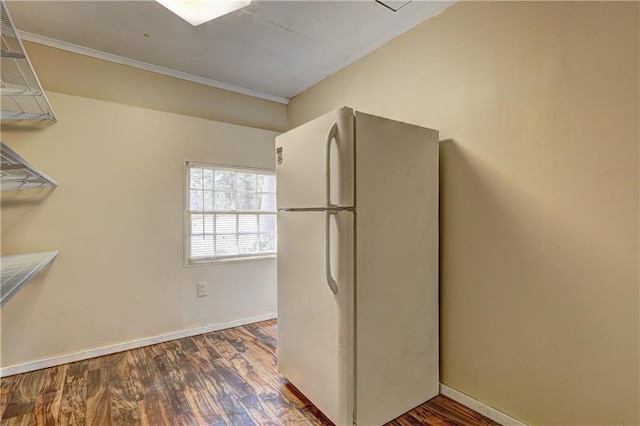 kitchen with white fridge and dark hardwood / wood-style flooring