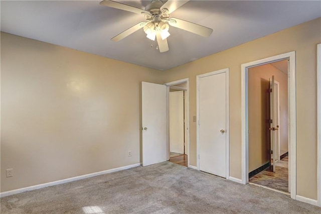 unfurnished bedroom featuring ceiling fan and light carpet