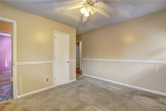 unfurnished bedroom featuring light colored carpet and ceiling fan