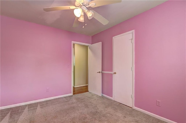 unfurnished bedroom with light carpet and ceiling fan