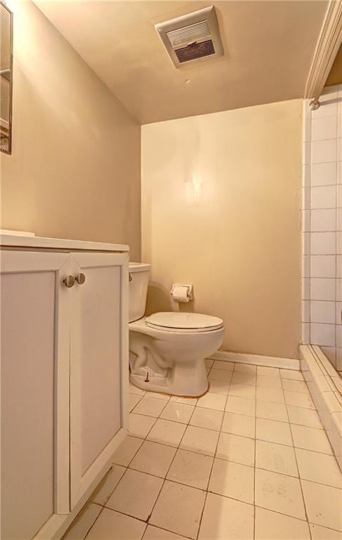 bathroom with toilet, tile patterned flooring, and a shower