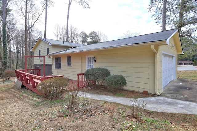 rear view of property with a garage