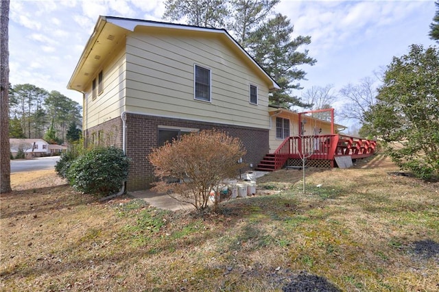 back of house with a lawn and a deck