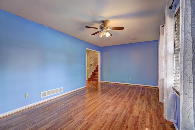 unfurnished room featuring hardwood / wood-style floors and ceiling fan