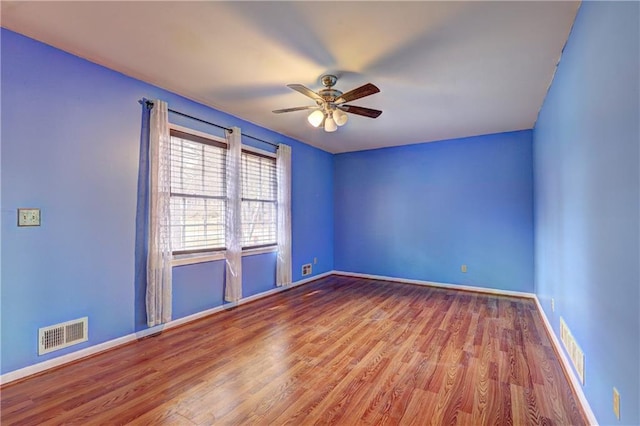 unfurnished room with hardwood / wood-style flooring and ceiling fan