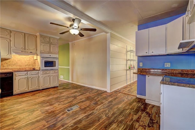 kitchen with ornamental molding, black dishwasher, hardwood / wood-style flooring, ceiling fan, and oven