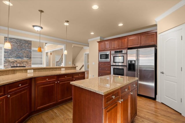 10565 Highgate Manor Ct, Duluth, GA 30097 - kitchen featuring appliances with stainless steel finishes, ornamental molding, light wood-type flooring, hanging light fixtures, and light stone countertops