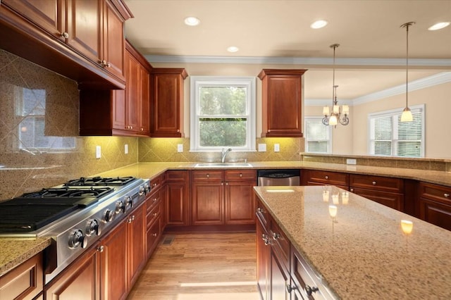 10565 Highgate Manor Ct, Duluth, GA 30097 - kitchen featuring stainless steel appliances, ornamental molding, plenty of natural light, hanging light fixtures, and light stone counters