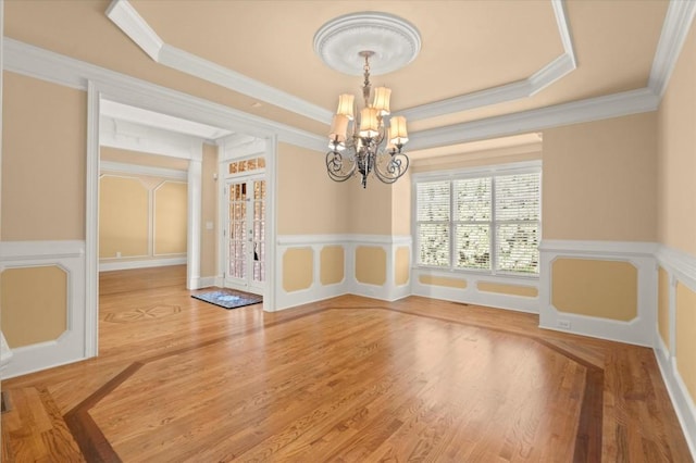 10565 Highgate Manor Ct, Duluth, GA 30097 - unfurnished dining area featuring a chandelier, ornamental molding, and wood finished floors