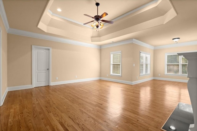 10565 Highgate Manor Ct, Duluth, GA 30097 - unfurnished living room featuring a raised ceiling, ornamental molding, wood finished floors, and a ceiling fan