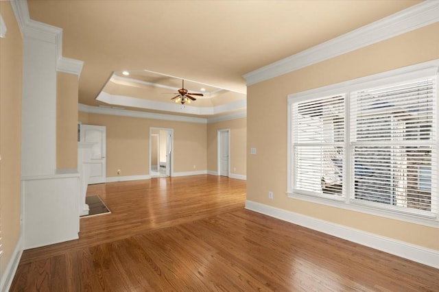 10565 Highgate Manor Ct, Duluth, GA 30097 - unfurnished living room featuring ornamental molding, a ceiling fan, wood finished floors, a tray ceiling, and recessed lighting