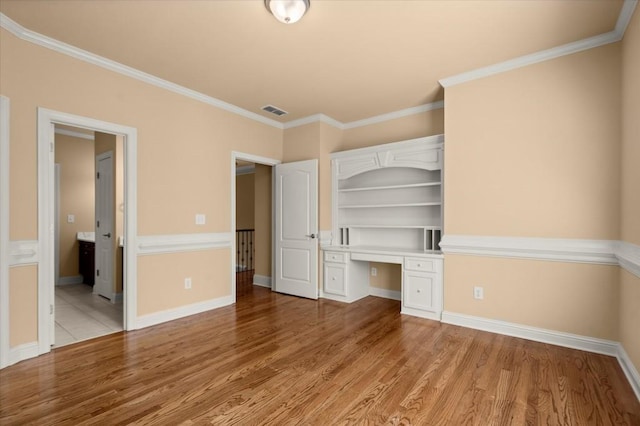 10565 Highgate Manor Ct, Duluth, GA 30097 - unfurnished bedroom with built in study area, light wood-style floors, and crown molding