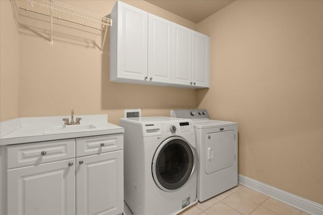 10565 Highgate Manor Ct, Duluth, GA 30097 - laundry area featuring cabinet space, washing machine and dryer, and light tile patterned floors