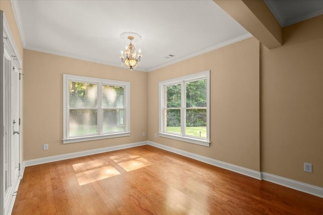 10565 Highgate Manor Ct, Duluth, GA 30097 - spare room with a chandelier, light wood-type flooring, and crown molding