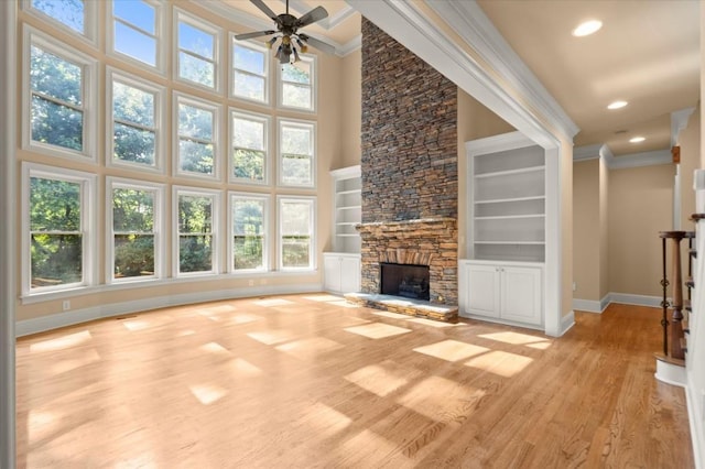 10565 Highgate Manor Ct, Duluth, GA 30097 - unfurnished living room featuring ornamental molding, healthy amount of natural light, ceiling fan, light wood-style flooring, and recessed lighting