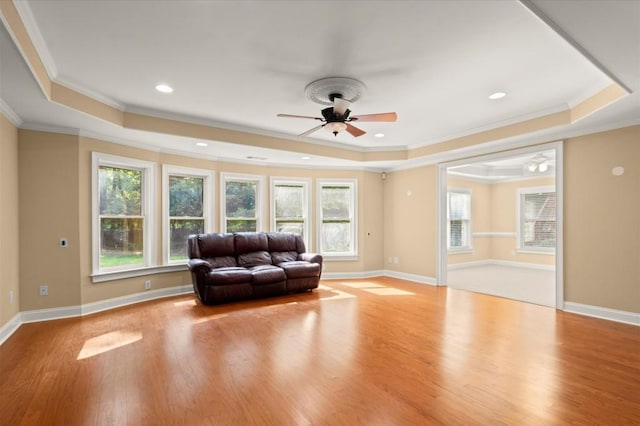 10565 Highgate Manor Ct, Duluth, GA 30097 - living area with a raised ceiling, ornamental molding, a ceiling fan, wood finished floors, and recessed lighting